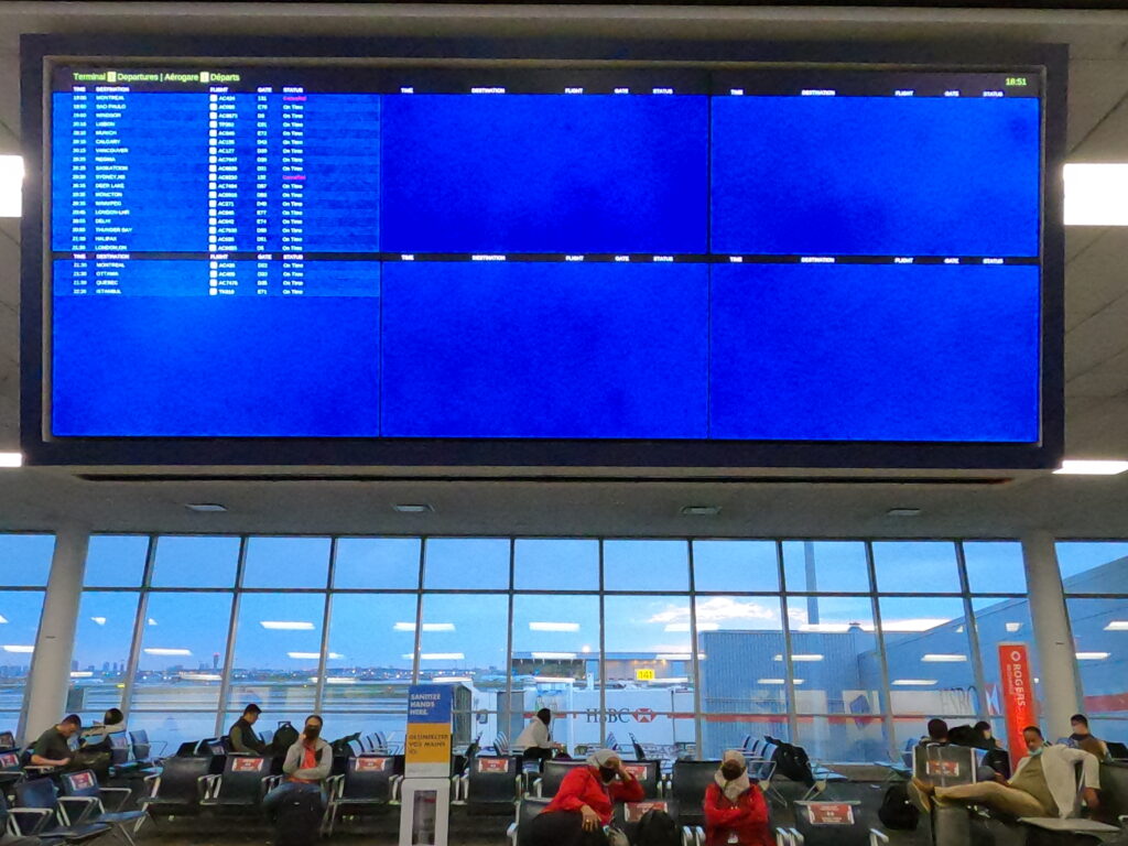 flight departure board at Pearson International Airport
