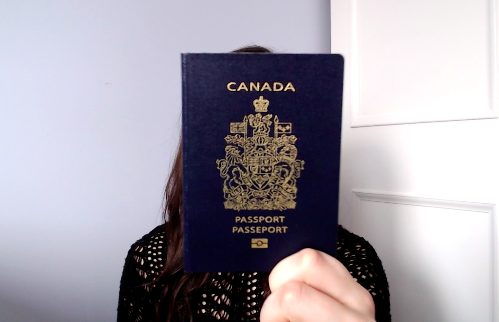 girl holding Canadian passport