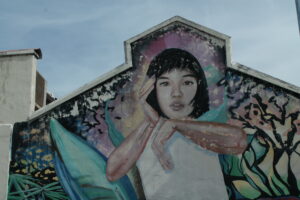 Street art, of a young girl with short black hair in Ipoh Malaysia.