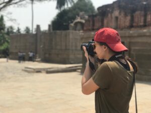 girl taking photograph with red hat