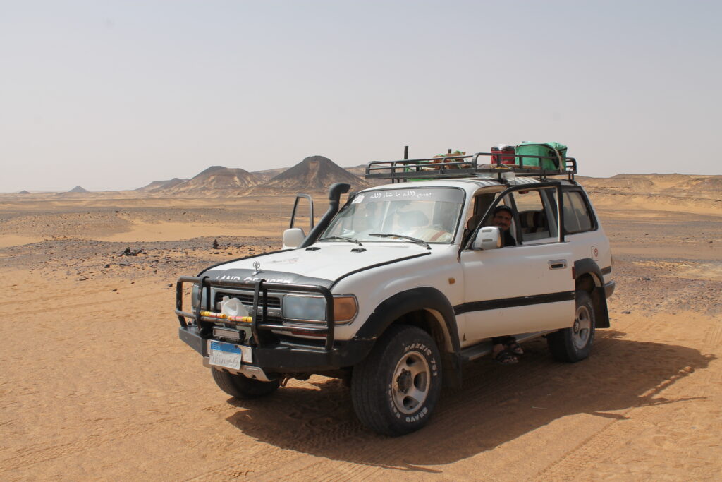 Guide and white jeep from White Desert Tour in Black Desert.