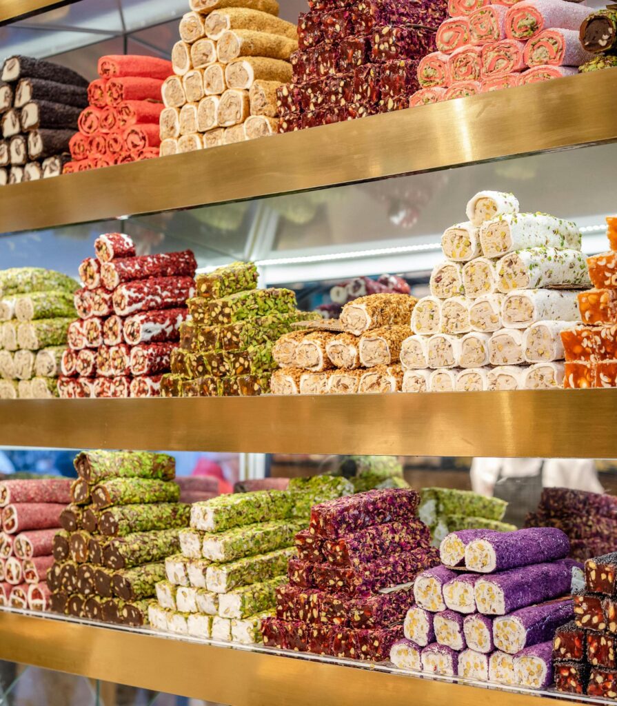 Rows of colorful stacked Turkish delight in various flavours.